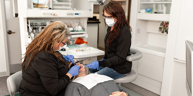 Bremerton dentists, our-assistants-checking-the-patients-teeth-in-the-office Safe Harbor Smiles